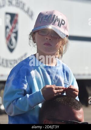 Dunmore, United States. 17th Oct, 2020. A young Trump supporter siting on her fathers shoulders at the Road Scholar, Trucking company during the rally.Eric Trump speaks to approximately 400 people in Dunmore, PA, it's the city adjacent to Joe Biden's childhood home of Scranton. March of the audience was made up of a group called Japan 4 Donald Trump, as Eric Trump speaks of gun rights and Amy Coney Barrett. Credit: SOPA Images Limited/Alamy Live News Stock Photo