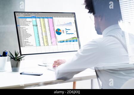 African American Hand Using Computer For Spreadsheet Data Work Stock Photo