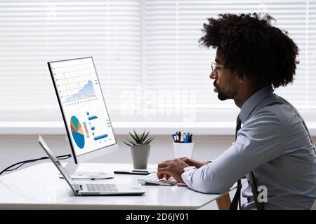 African American Financial Advisor Using Business Laptop Computer Stock Photo