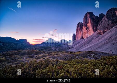 Panoramic view on the north faces of the mountain group Tre Cime di Lavaredo at sunrise. Stock Photo