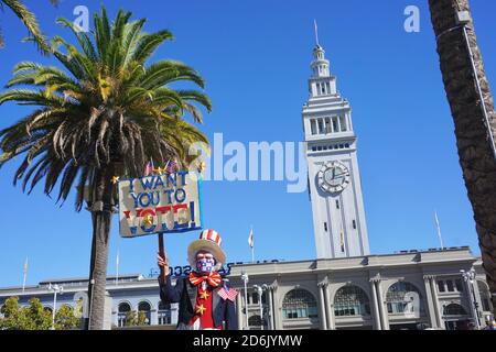 October 17, 2020. Protester dressed up as Uncle Sam holds up a Vote sign before the USA Presidential Election. San Francisco Ferry Building, CA. Stock Photo