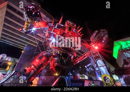 A giant robot sculpture with colorful red lighting, part of the annual 'Vivid Sydney' festival in Sydney, Australia Stock Photo
