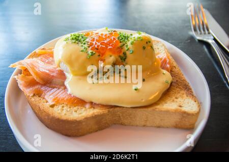 Eggs Benedict Royal, with smoked Salmon, poached eggs, Hollandaise sauce, Caviar and scallion, over a fresh brioche bread. Stock Photo