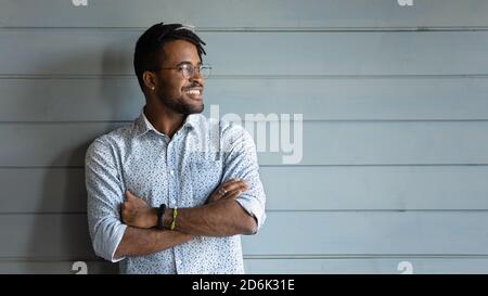 Smiling biracial man look in distance dreaming planning Stock Photo