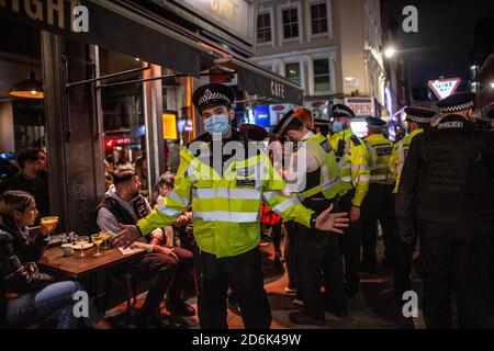 Police on patrol on Old Compton Street during what is percieved as the Last Night of Freedom as Tier 2 Lockdown is enforced on gatherings at restaurants and bars in Soho, London, UK Credit: Jeff Gilbert/Alamy Live News Stock Photo