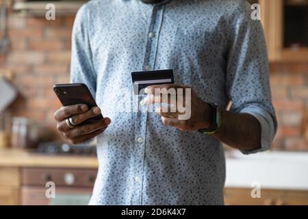Biracial man shopping online paying with credit card Stock Photo