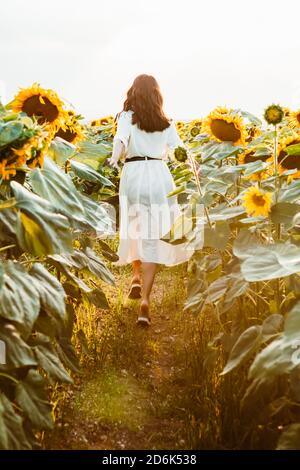 Back view of beautiful stunning young girl in light yellow dress ...