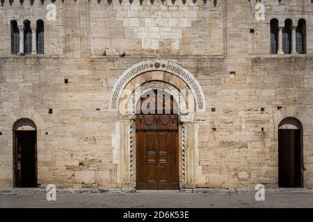 Old wooden medieval door with beautiful ornaments in a stone wall Stock Photo