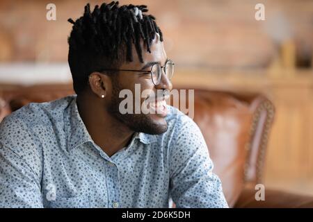 Happy African American man look in distance dreaming Stock Photo