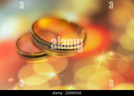 wedding rings in warm colors with reflection Stock Photo