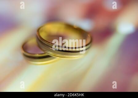 wedding rings in warm colors with reflection Stock Photo