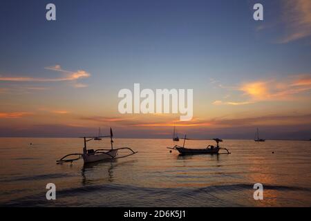 sunrise over fishing boats on Bali. Stock Photo