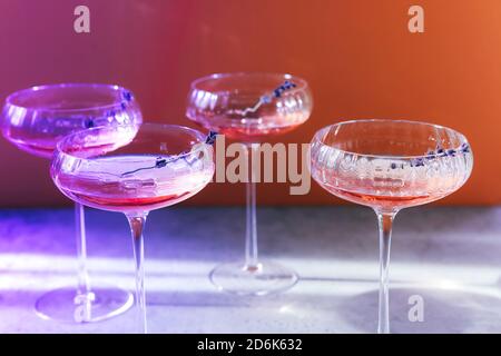 Set of glass goblets with champagne and flowers placed on table in restaurant Stock Photo