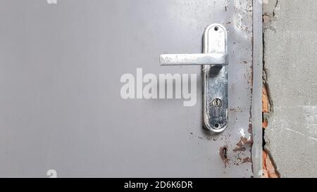 Old metal doorknob on an old door. Rust on the doorknob Stock Photo