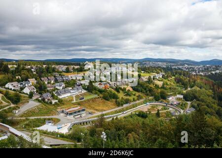 View of Winterberg and the surrounding forests and hills under a cloudy sky. Hochsauerland, North Rhine-Westphalia, Germany. Stock Photo