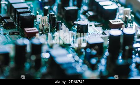Close-up Macro Shot of Electronic Printed Circuit Board with Microchips, Transistors, Semiconductors, Capacitors on the Motherboard. Stock Photo
