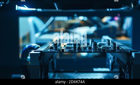 Automated Robotic Industrial Equipment is Testing Electronic Printed Circuit Board with Light and Laser Technology After Assembly. Stock Photo
