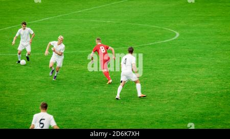 Professional Soccer Players Playing Pass Trying to Score a Goal. Impressive Professional Match on International Championship. Stock Photo