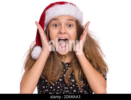 Happy teen girl in Santa red hat, isolated on white background Stock Photo