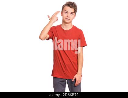 Handsome teen boy pointing hand and fingers to head like gun, suicide gesture, isolated on white background Stock Photo