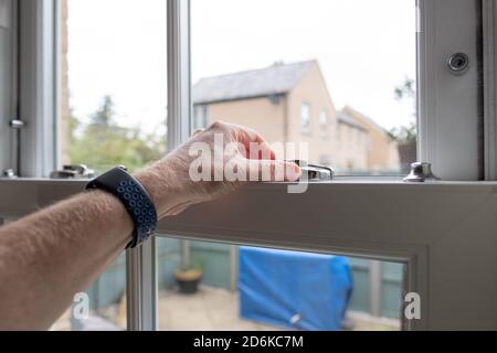 Detailed view of a newly installed, energy saving double glazed sash window looking to small patio area. Stock Photo