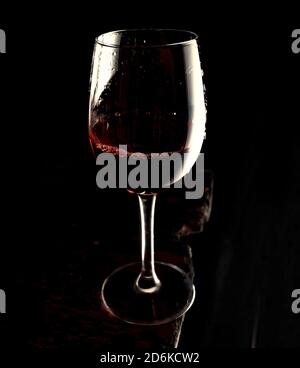 Red wine in glass on dark old board, copy space Stock Photo