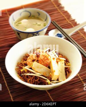 Asian food soy sauce noodle with fishcake, shrimp and fish balls soup Stock Photo