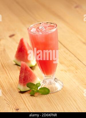 Glass of watermelon juice on wooden table Stock Photo