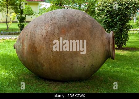 A Qvevri is a large earthenware vessel originally from Georgia, Caucasus. It is used for the fermentation and storage of wine, often buried below grou Stock Photo