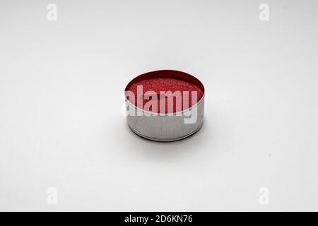 Small decorative red candles in metal case isolated on a white background Stock Photo