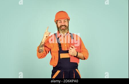 builder in hardhat. apartment under repair portrait. Estimated property value concept. industry and paperwork. Worker with happy face. Inspector checking and inspecting building using checklist. Stock Photo