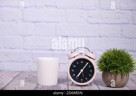coffee mug and clock on table close up  Stock Photo