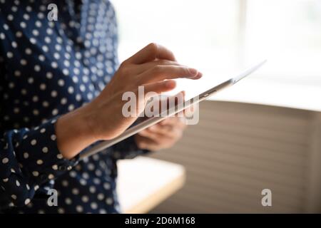 Cropped closeup view female hands using tablet gadget Stock Photo