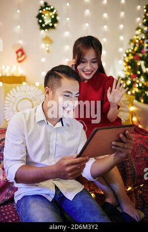 Couple video calling relatives and friends Stock Photo