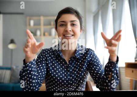 Webcam view Indian woman sit indoor talking using videoconference application Stock Photo