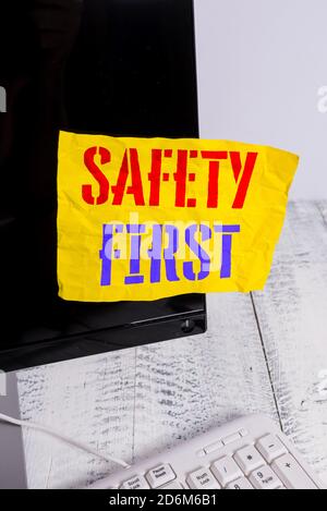 Writing note showing Safety First. Business concept for Avoid any unnecessary risk Live Safely Be Careful Pay attention Notation paper computer monito Stock Photo