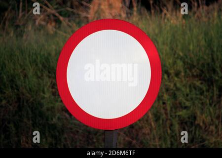 white and red traffic sign on road with no indication, blank, mockup Stock Photo