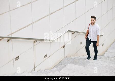 Businessman walking up the stairs Stock Photo