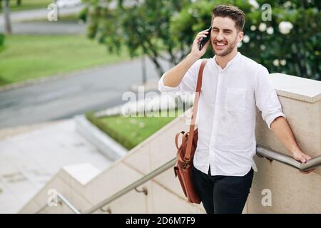 Cheerful man talking on phone Stock Photo