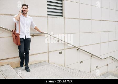 Positive man talking on phone Stock Photo