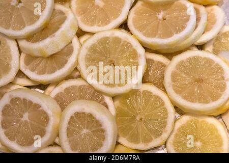 whole lemon and whole lime laying on a bed of sliced lemons and limes Stock Photo