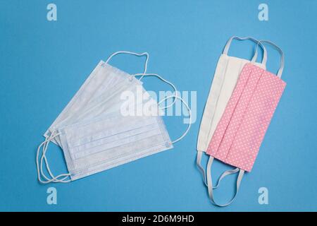 Five beautiful colored different reusable medical masks on blue isolated background. Hygienic, antimicrobial, antiviral tissue masks. Coronavirus prot Stock Photo