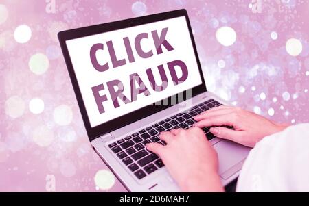 Text sign showing Click Fraud. Business photo text practice of repeatedly clicking on advertisement hosted website Modern gadgets with white display s Stock Photo