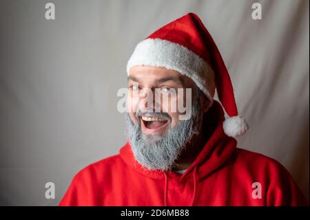 Santa Claus laughs at the camera with his mouth wide open Stock Photo