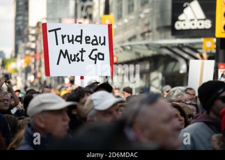 Protesters express dislike for Prime Minister Justin Trudeau at the 'March for Freedom' from COVID-19 restrictions in Toronto, Canada. Stock Photo