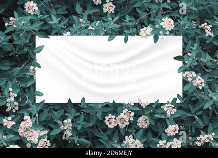 green leaves and flowers above crumpled fabric background Stock Photo