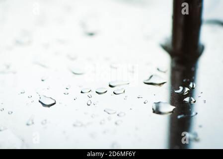 Abstract background from a drop of water on a glossy metal surface Stock Photo