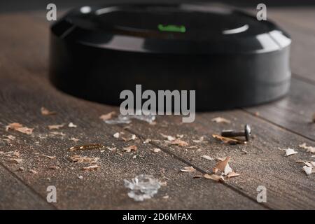 Close-up on dust and trash being collected by a black robotic va Stock Photo