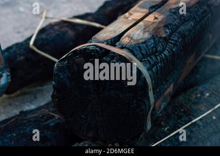 real burned wood log close up - charcoal production Stock Photo