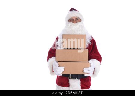 Senior man wearing a traditional Santa Claus costume holding a stack of cardboard boxes ready for delivery.  Isolated on white. Stock Photo